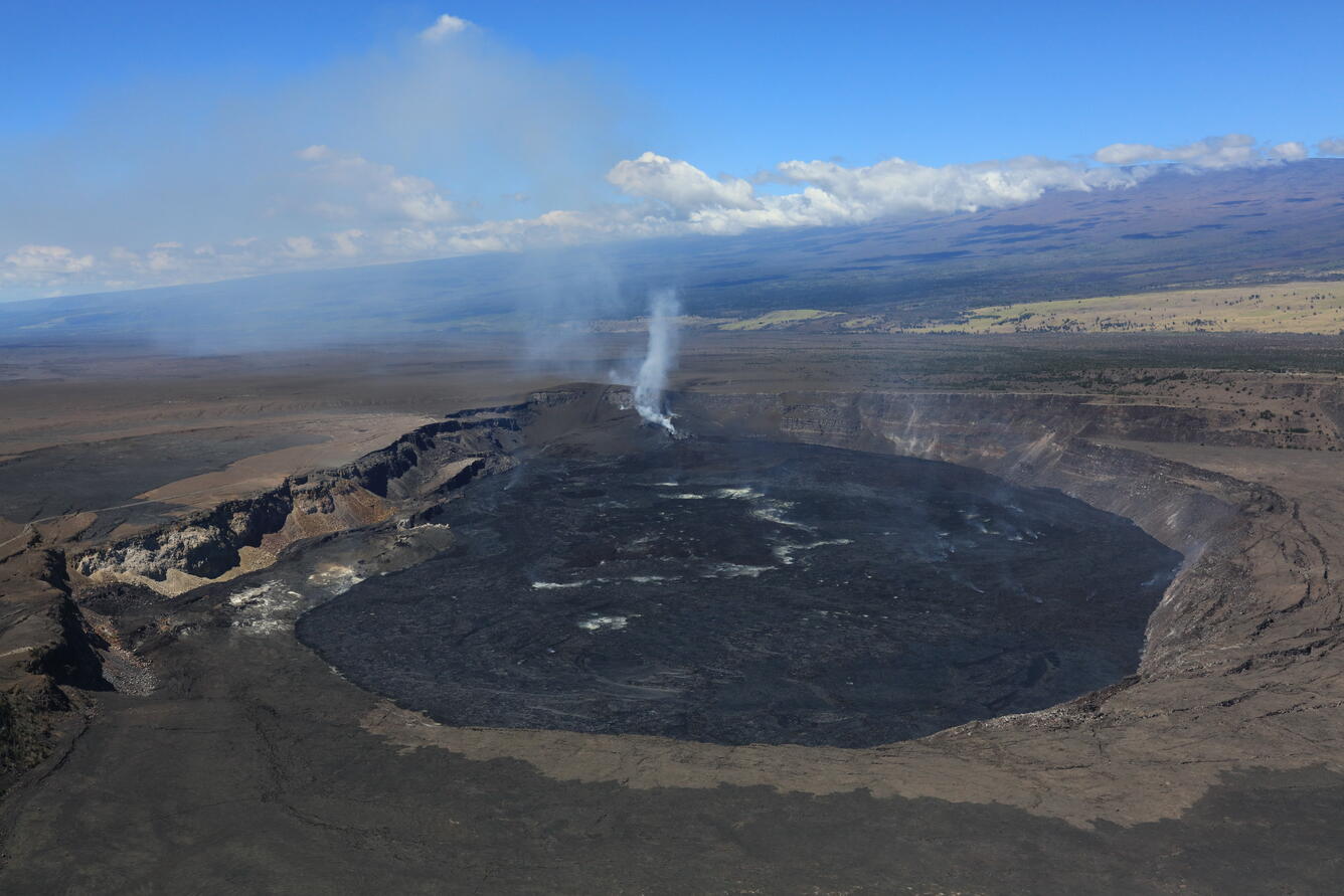 color photo of the Kaluapele with the steaming vents in the distance. 