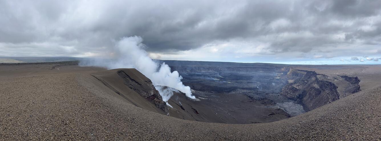 Color photograph of steaming volcanic crater