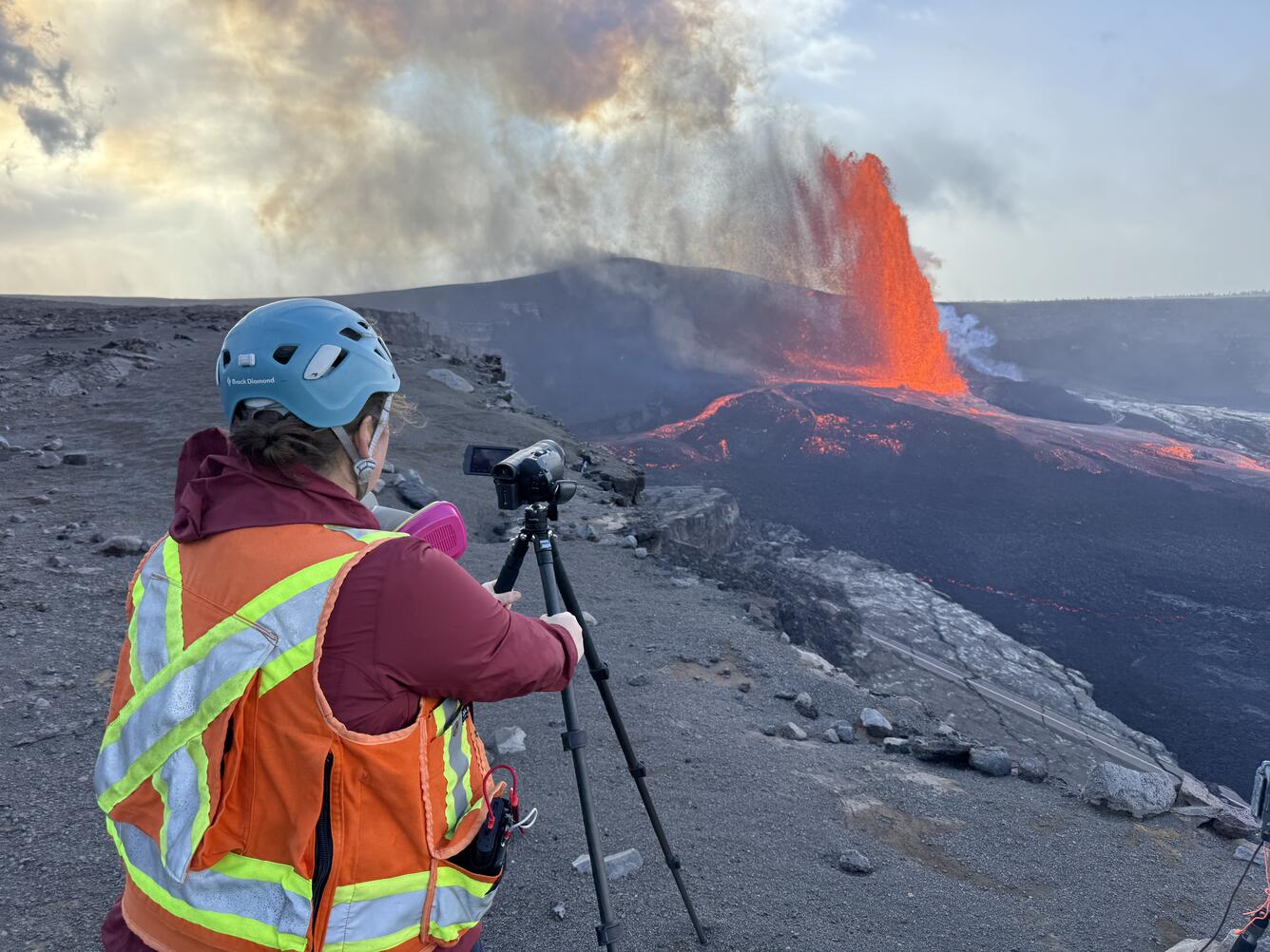 Color photograph of scientist monitoring volcanic eruption