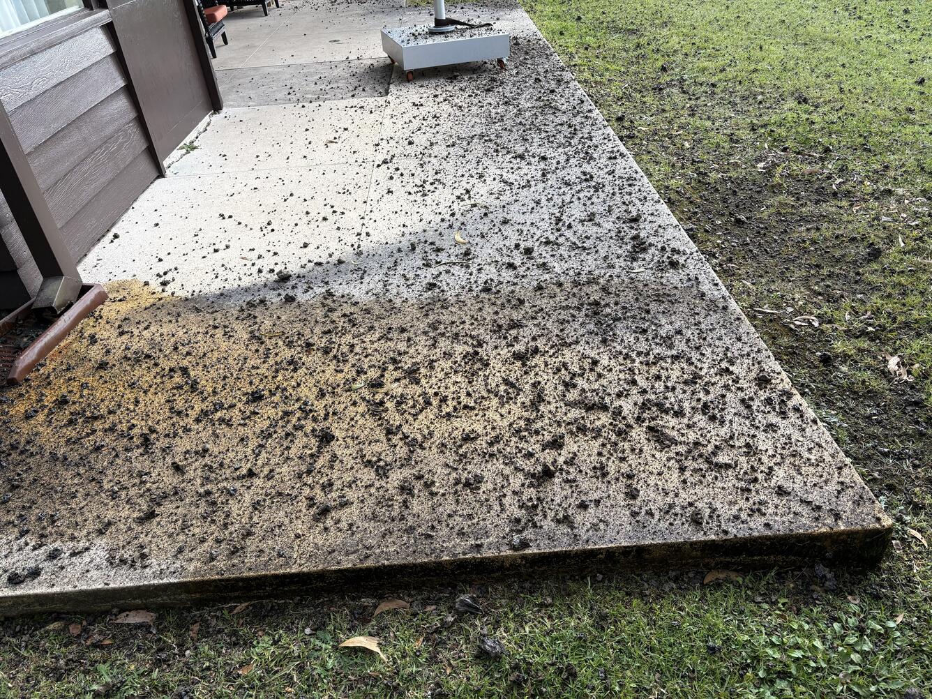Color photograph of volcanic rocks on a cement pad