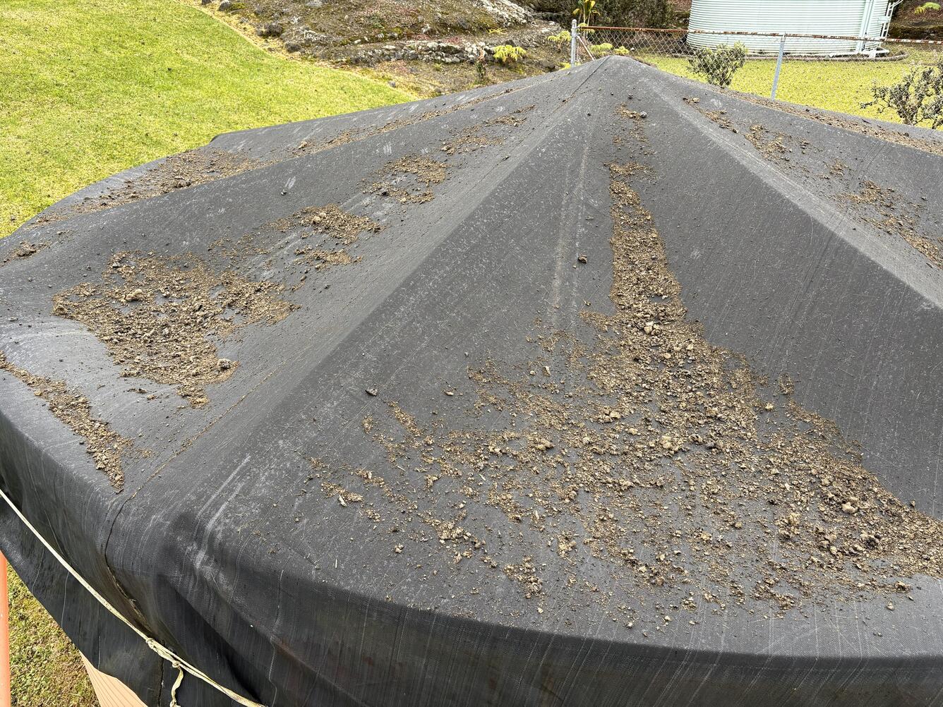 Color photograph of volcanic rocks on a water tank roof