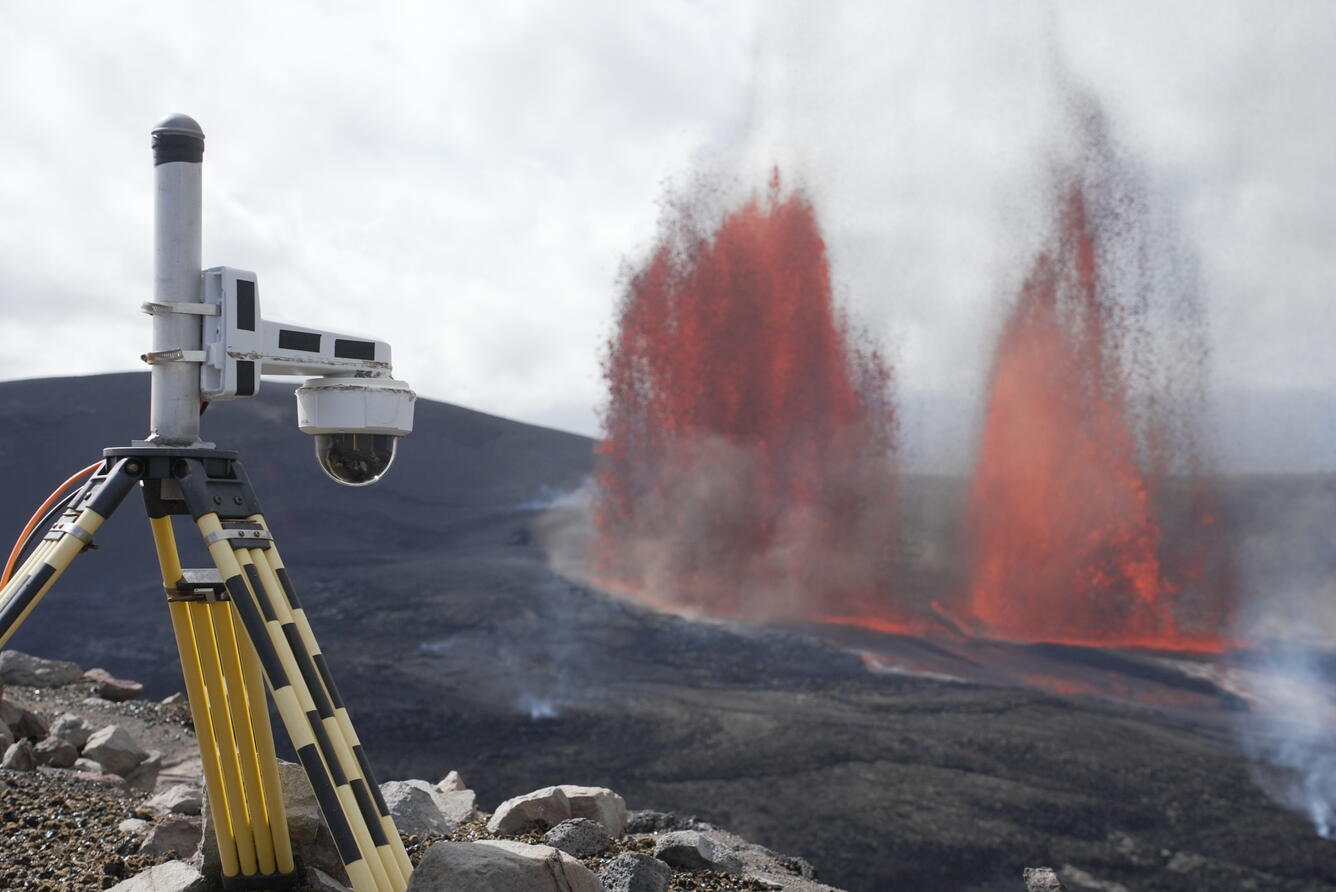 Color photograph of lava fountains and camera