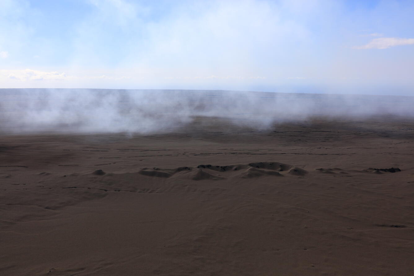 Color photograph of volcanic landscape blanketed with fallout from lava fountains