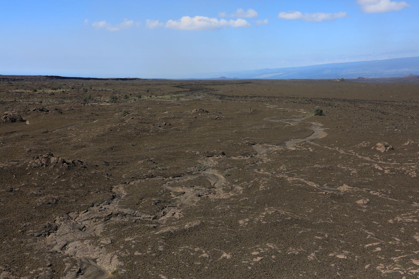 Color photograph of volcanic landscape with eroded tephra deposits
