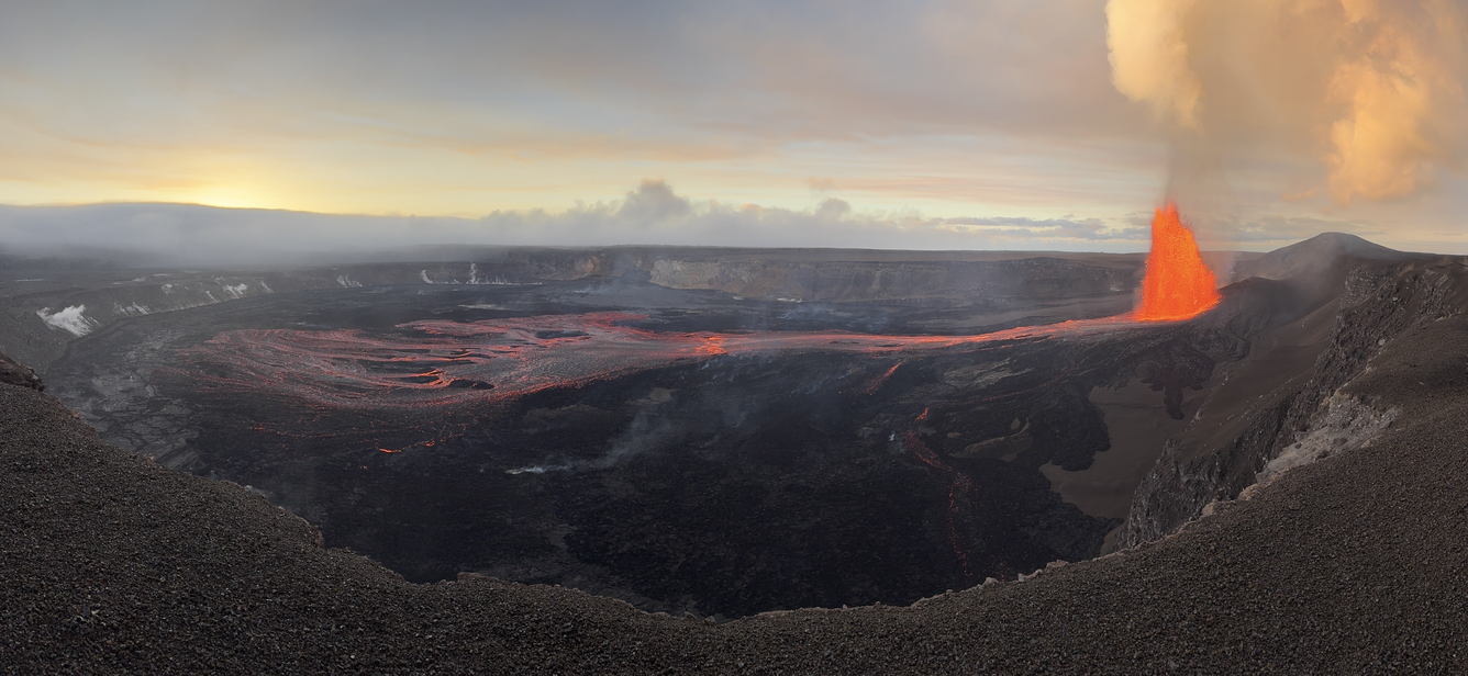 Color panoramic photograph of volcanic eruption within crater