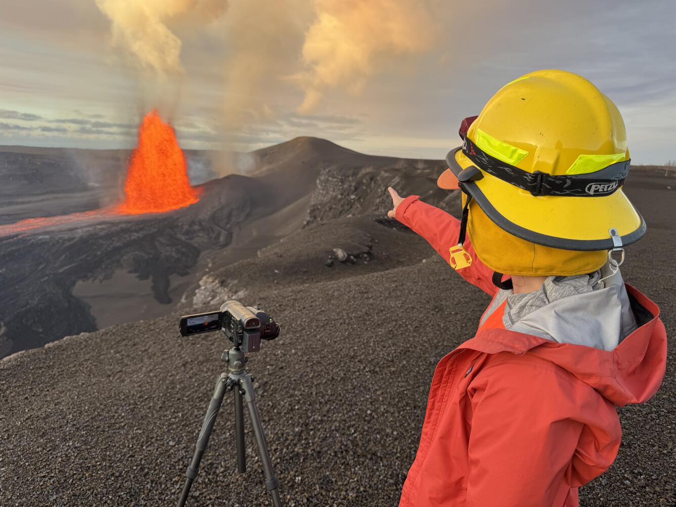 Color photograph of scientist monitoring volcanic eruption