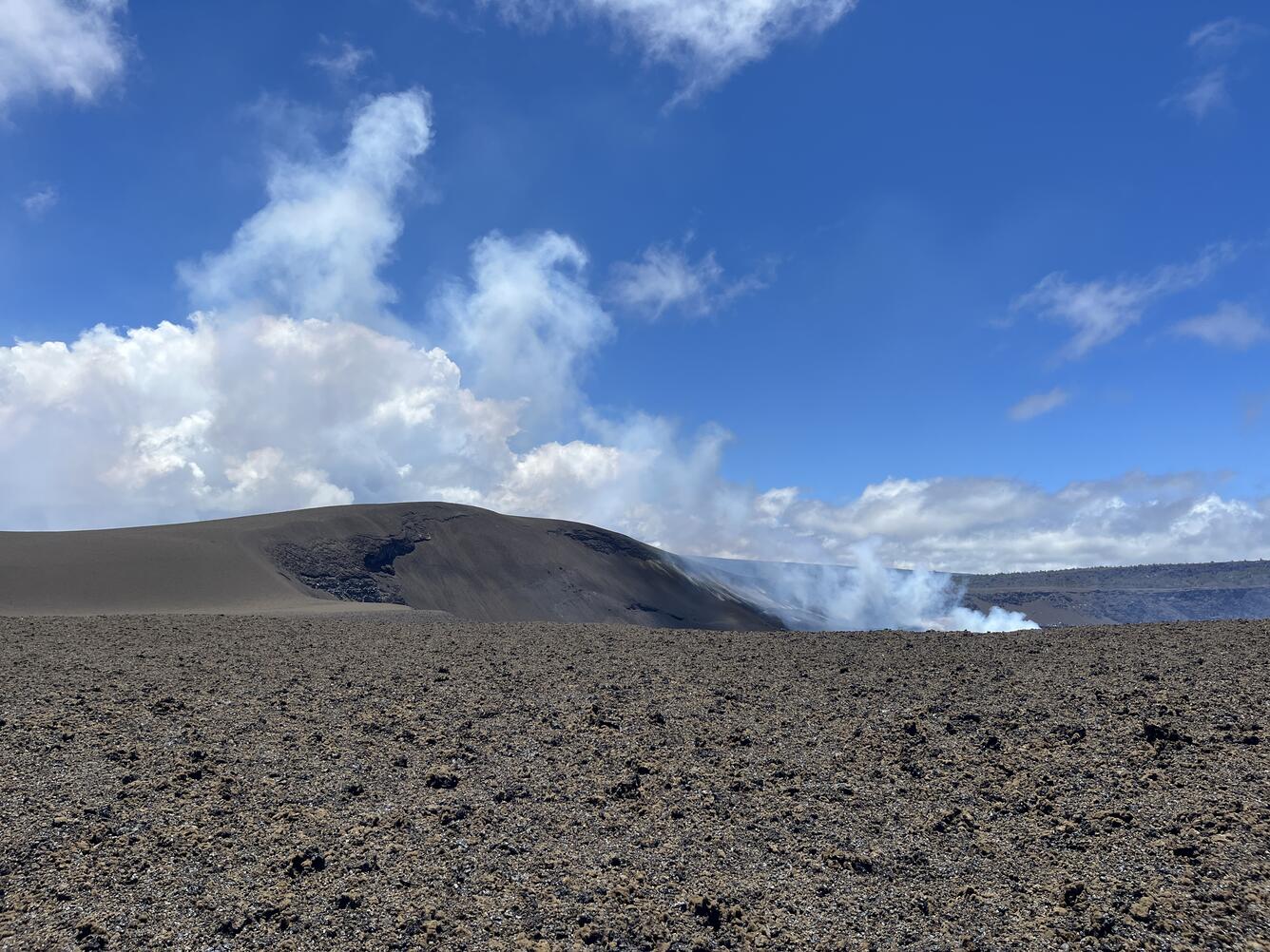 Color photograph of volcanic cone and volcanic degassing