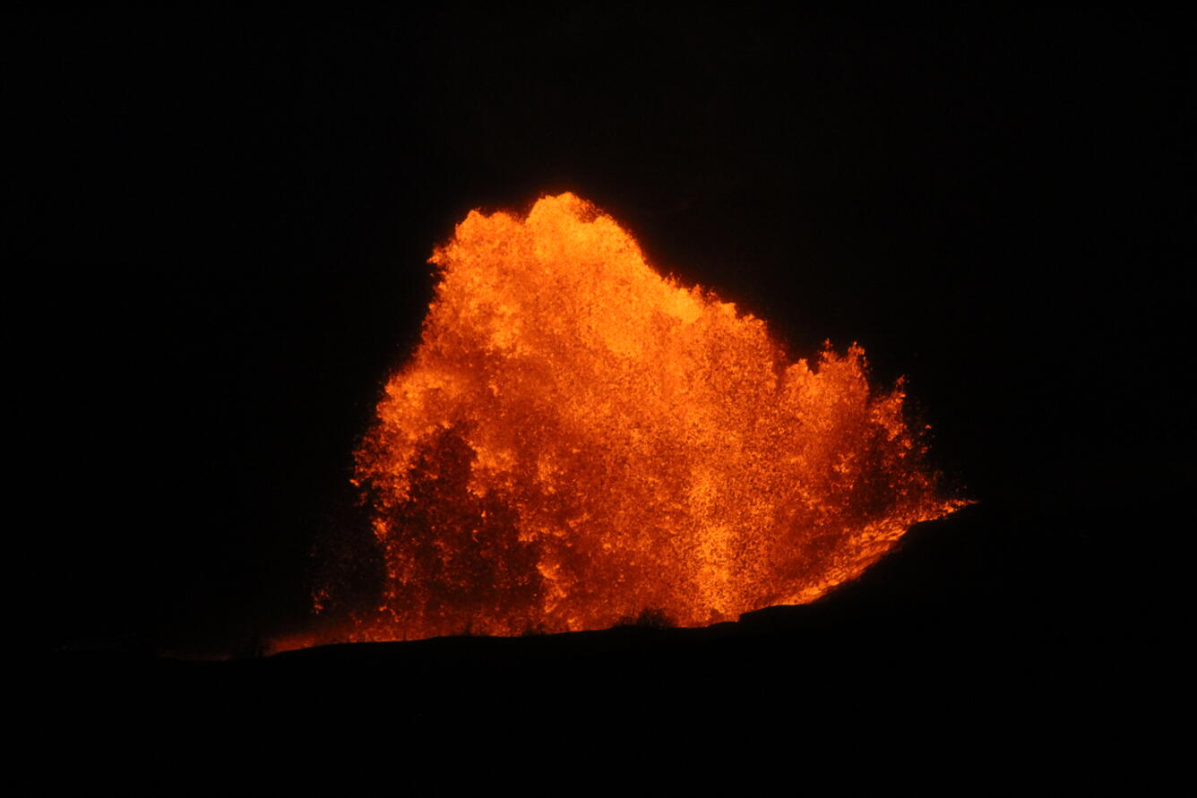 Color photograph of lava fountain at night