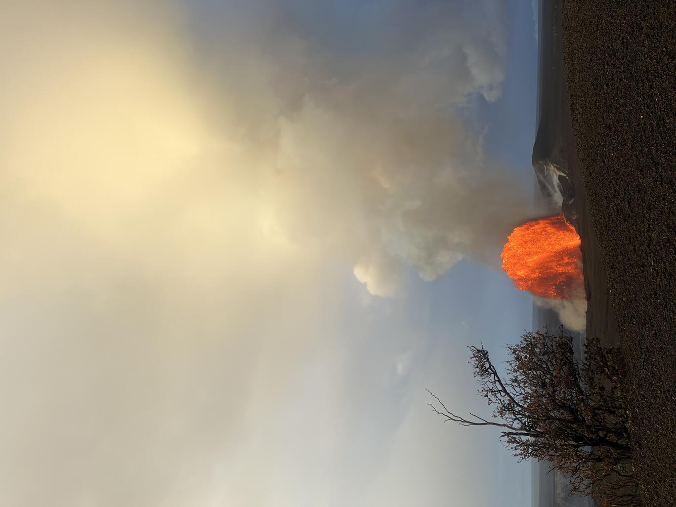Color photograph of lava fountain in the distance