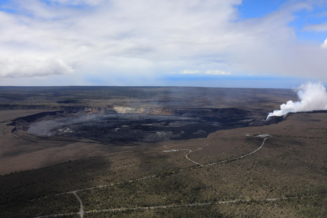 Color photograph of volcanic caldera with degassing vent