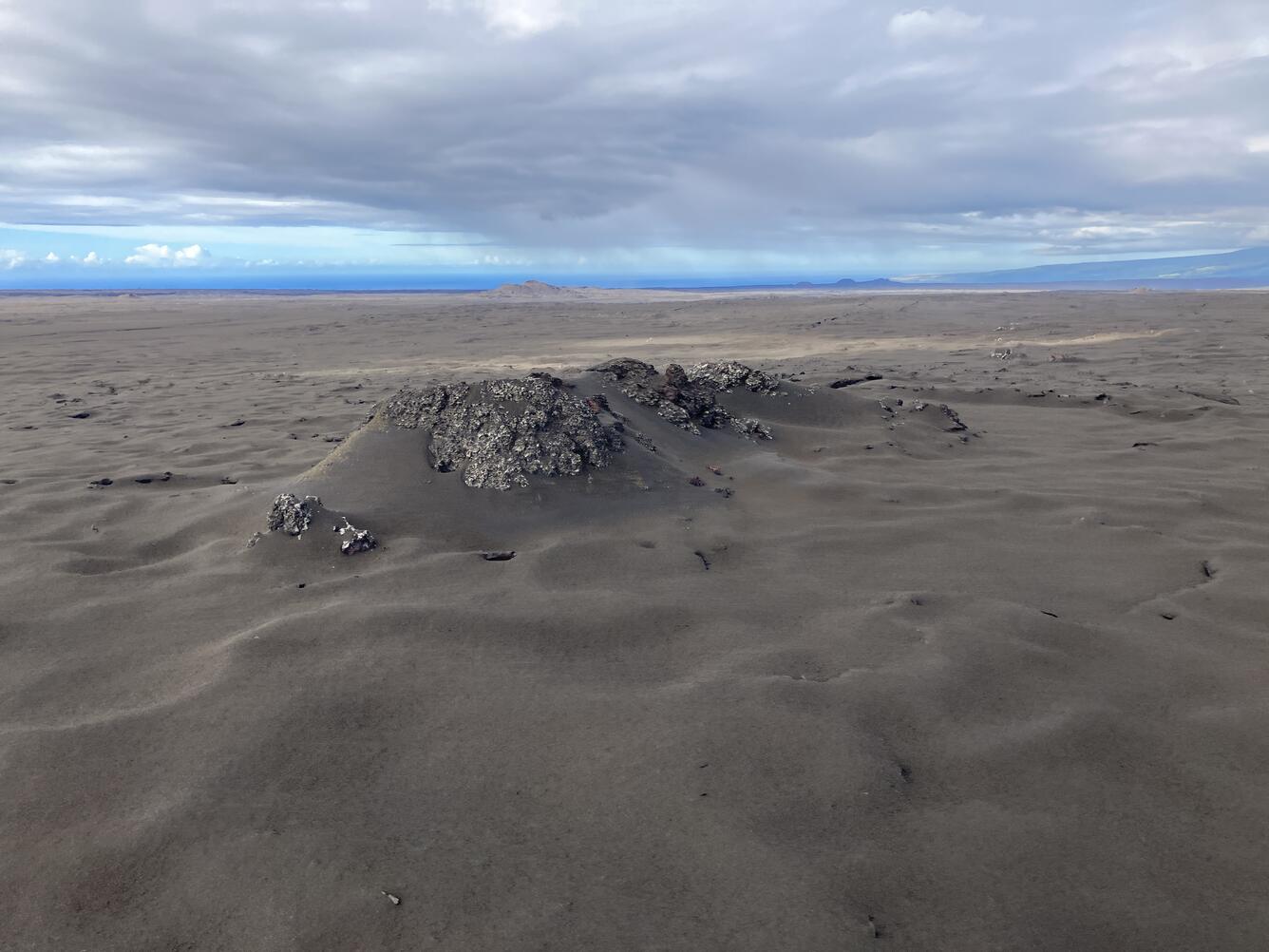 Color photograph of volcanic vent covered with tephra 