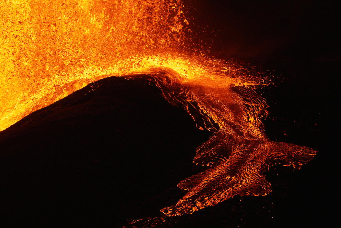 Color photograph of lava flow at night