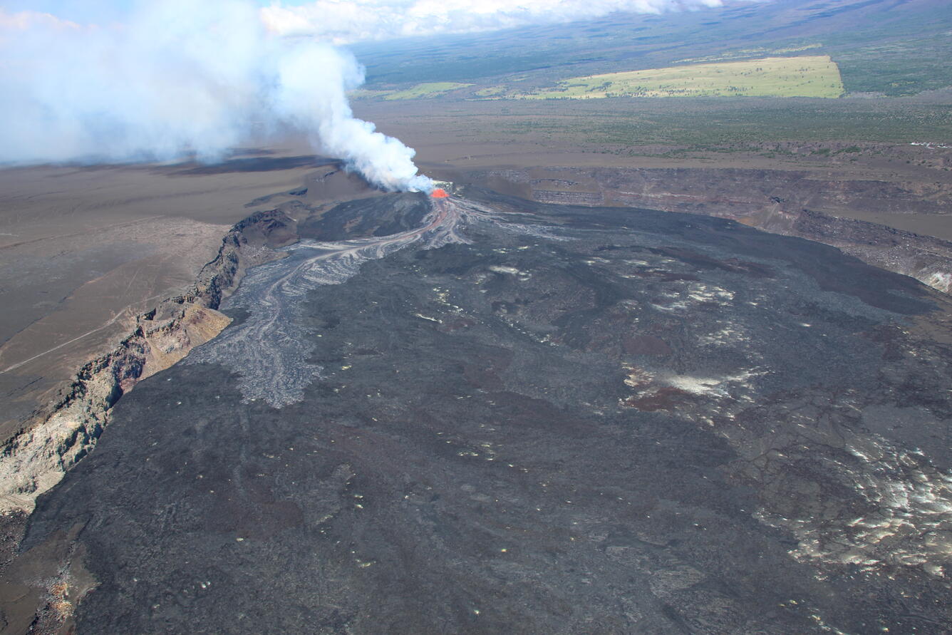 Color photograph of volcanic eruption within caldera