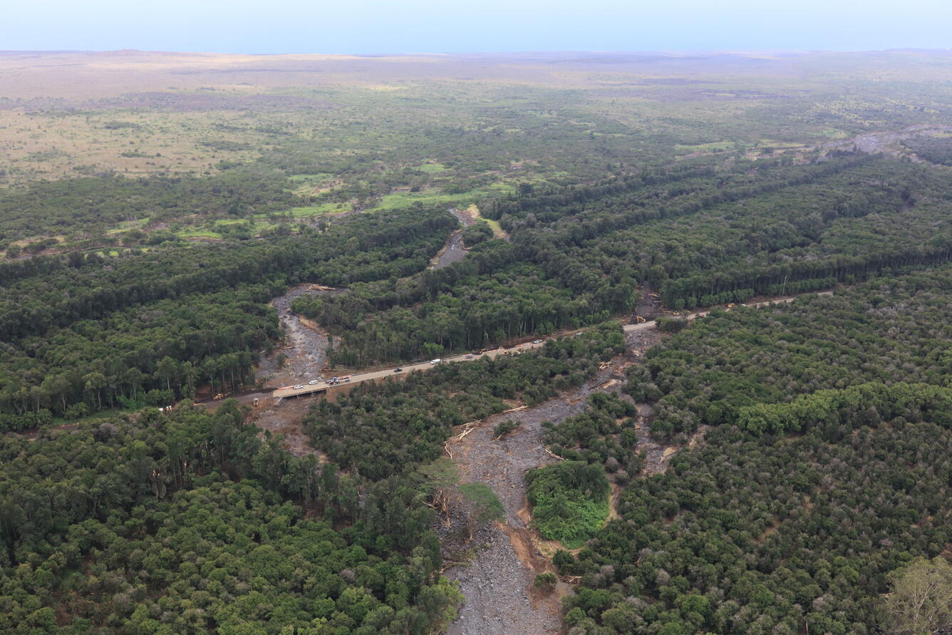 Color photograph of highway and flood-damaged areas