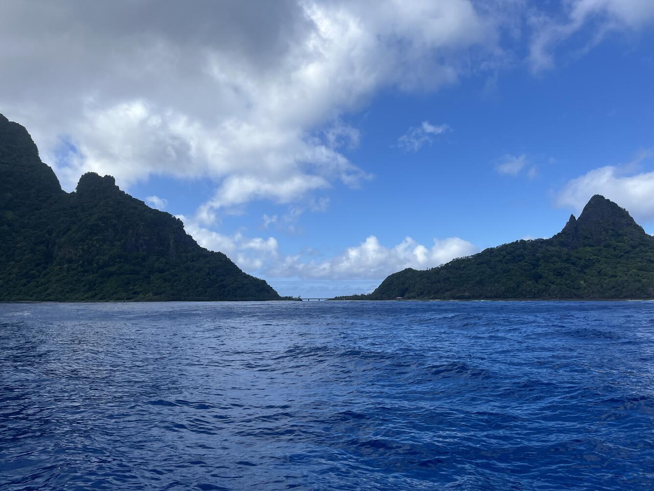Color photograph of ocean in foreground, island in background