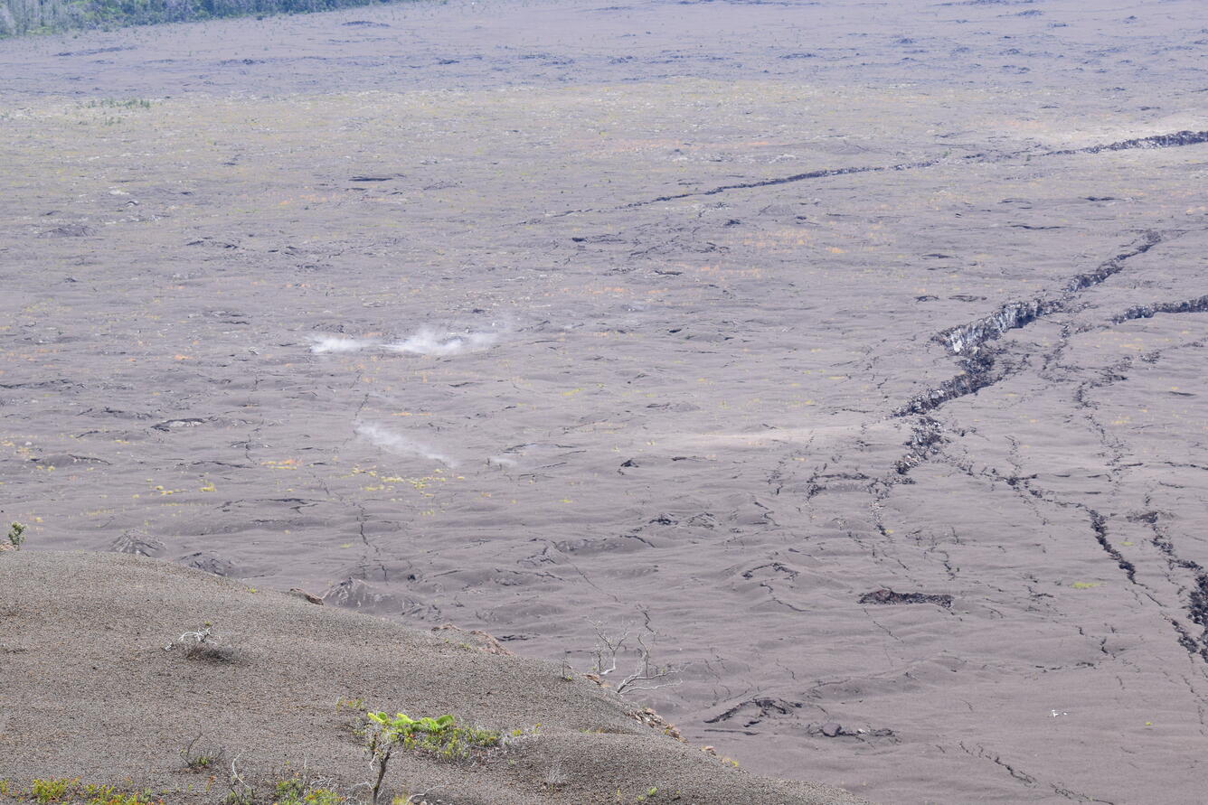 Color photograph of steaming ground cracks