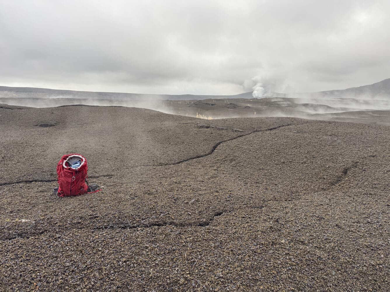 Color photograph of backpack next to crack