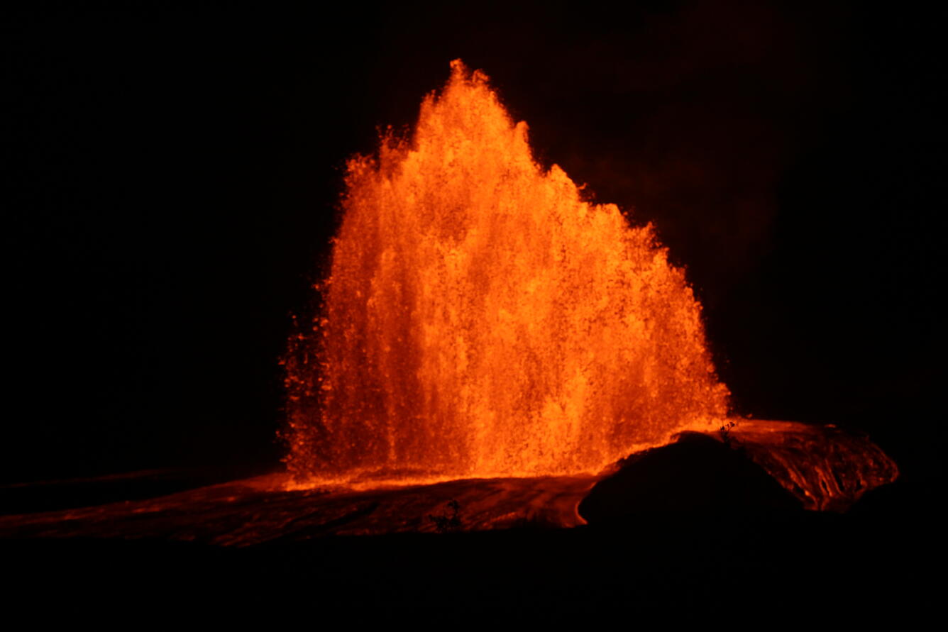 Color photograph of lava fountain at night