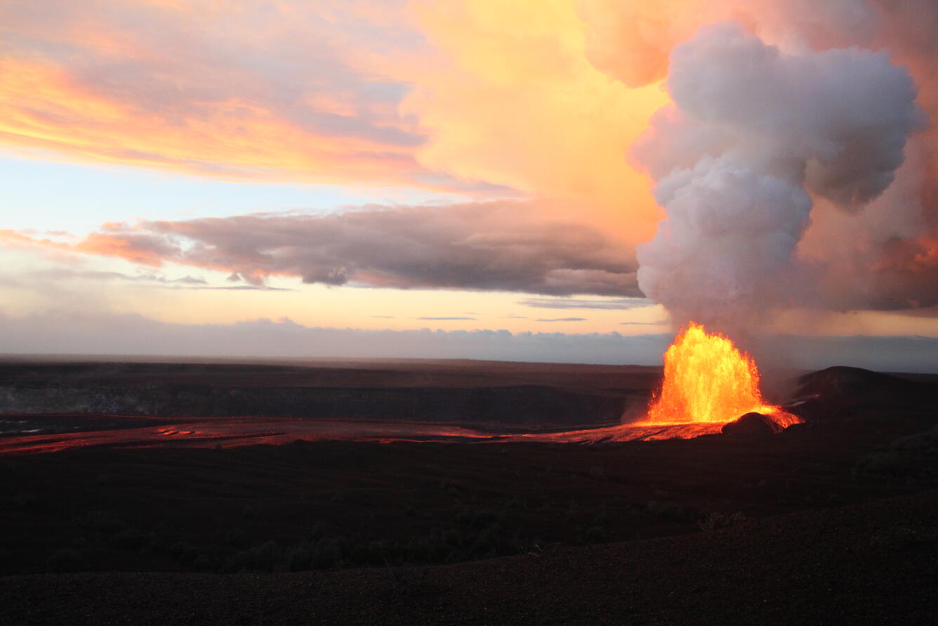 Color photograph of lava fountaining during sunrise