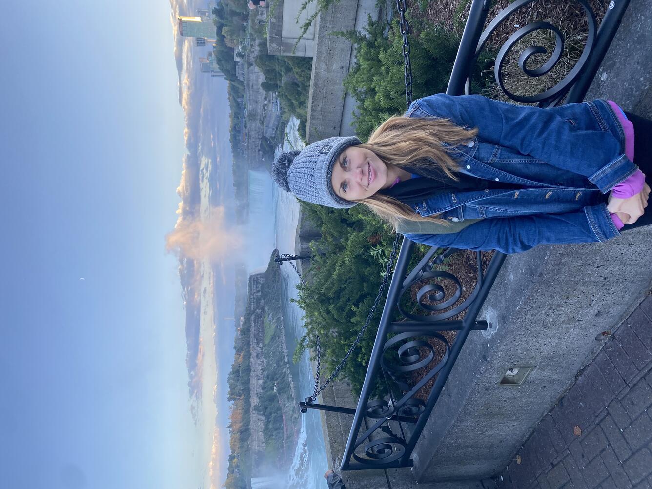Woman standing in front of waterfall