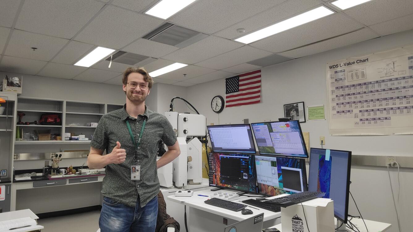 Nicholas E Powell gives a thumbs up while proudly showing off new lab equipment