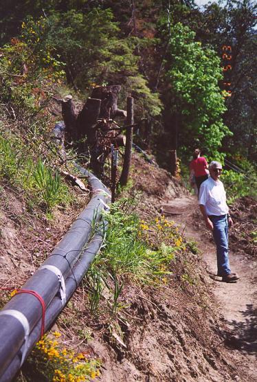pipeline running along edge of slope next to walking trail