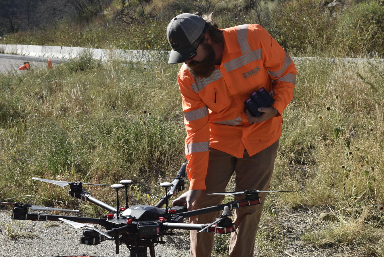 USGS remote pilot replaces UAS batteries during a mission at the Cimarron Canyon in New Mexico