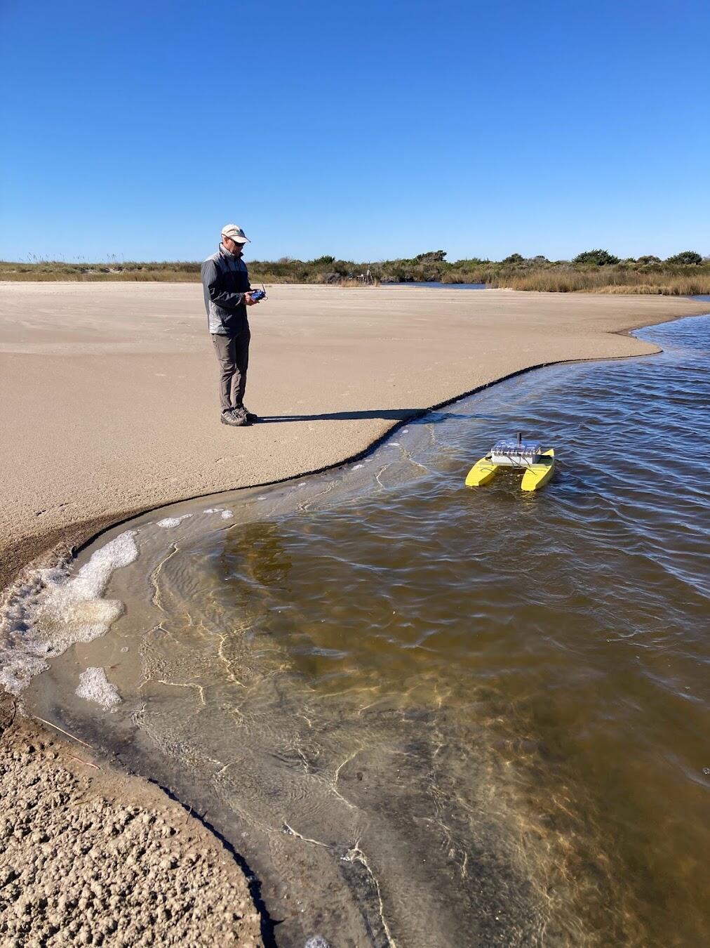 Chris Sherwood drives a remote controlled surface vehicle named the Yellow Cat