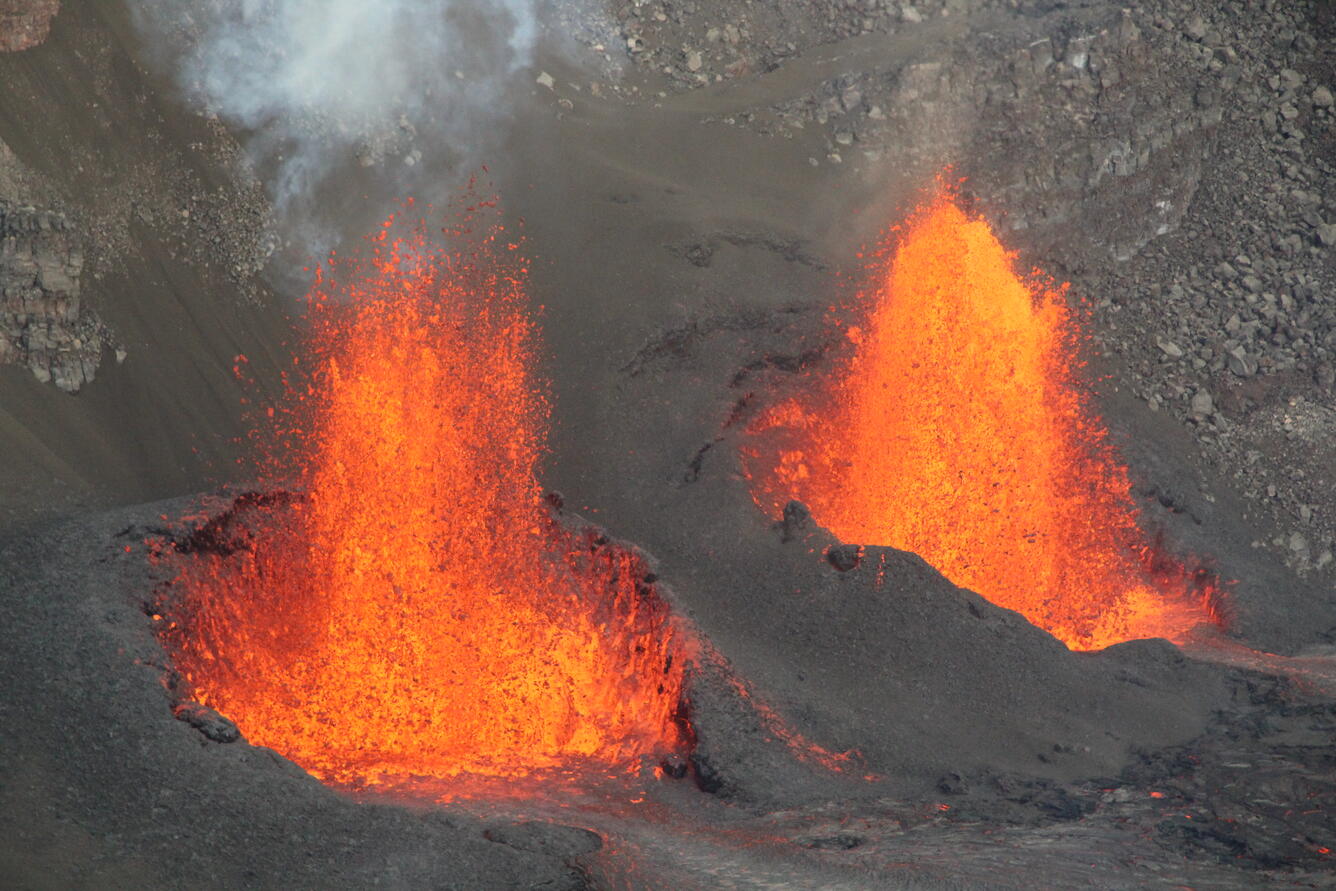 Color photograph of two lava fountains erupting