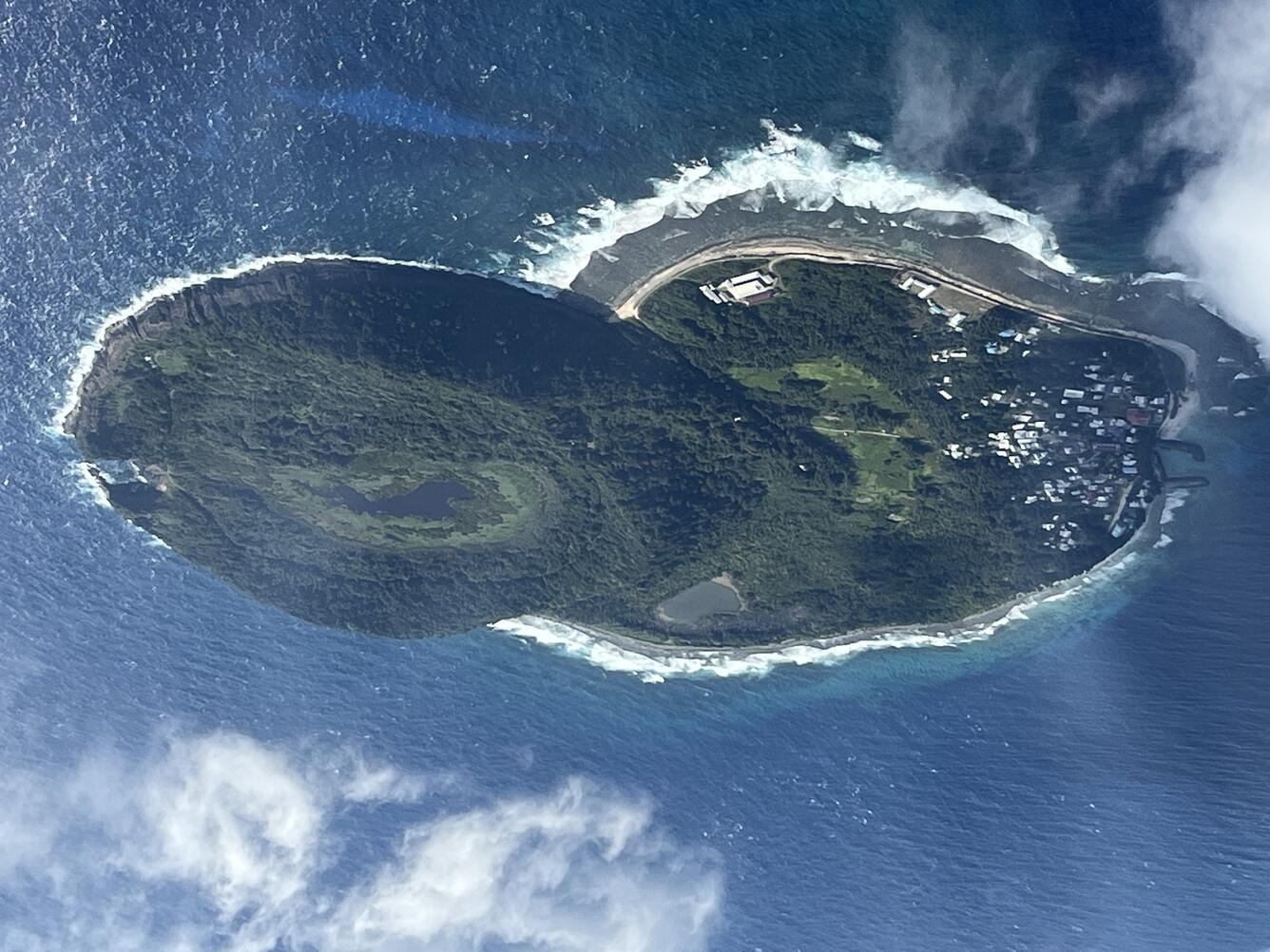 Color photo looking down at Aunu‘u Island from the air during a flight. 