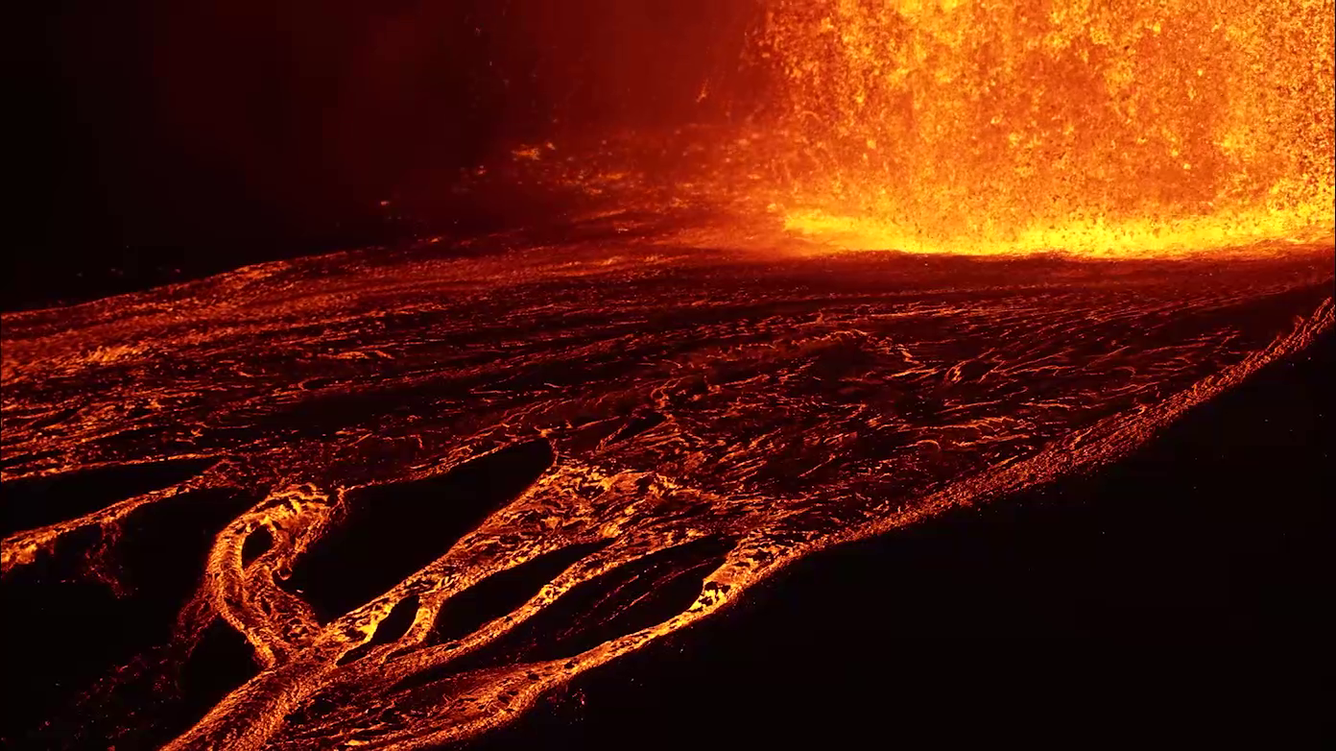 Color photograph of lava channels flowing away from lava fountain