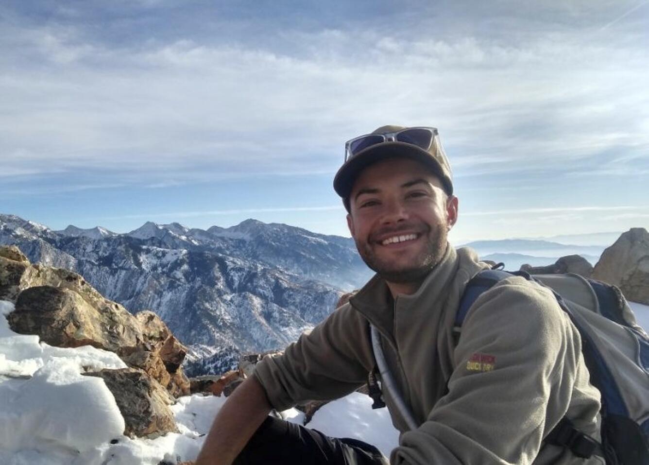 Staff profile of Sam Lopez in front of mountain vista.