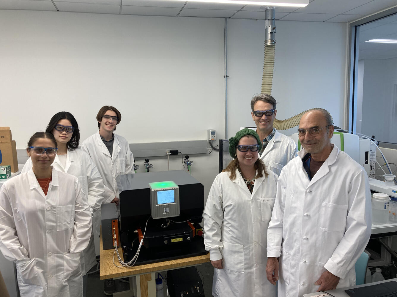 Photo showing staff members of the Selenium Bioaccumulation and Contaminant Research Laboratory standing near lab equipment.