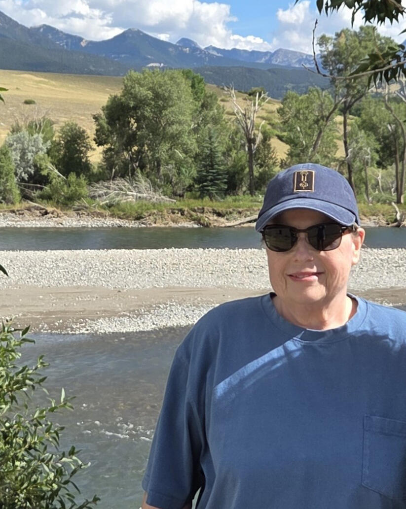 headshot portrait of Jaime McBeth in Yellowstone with stream and mountains in background