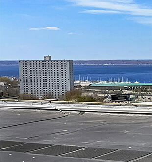 Left side of image: Sam Banas performing a calibration test of a precipitation tipping bucket instrument