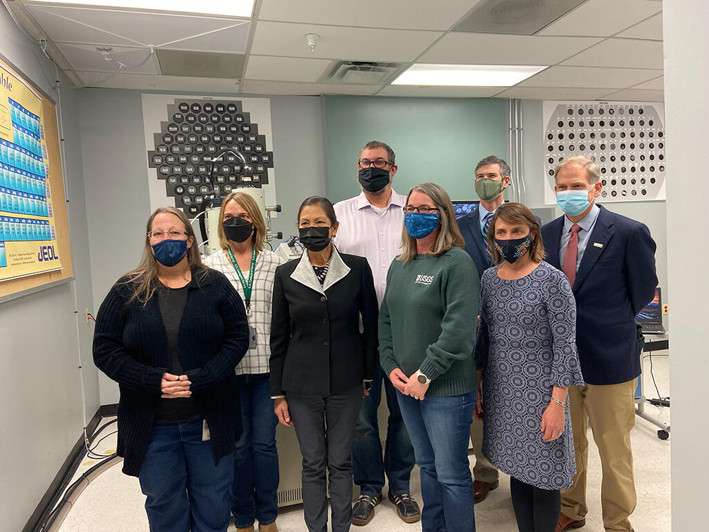 DOI visitors with GGGSC scientists standing in hall
