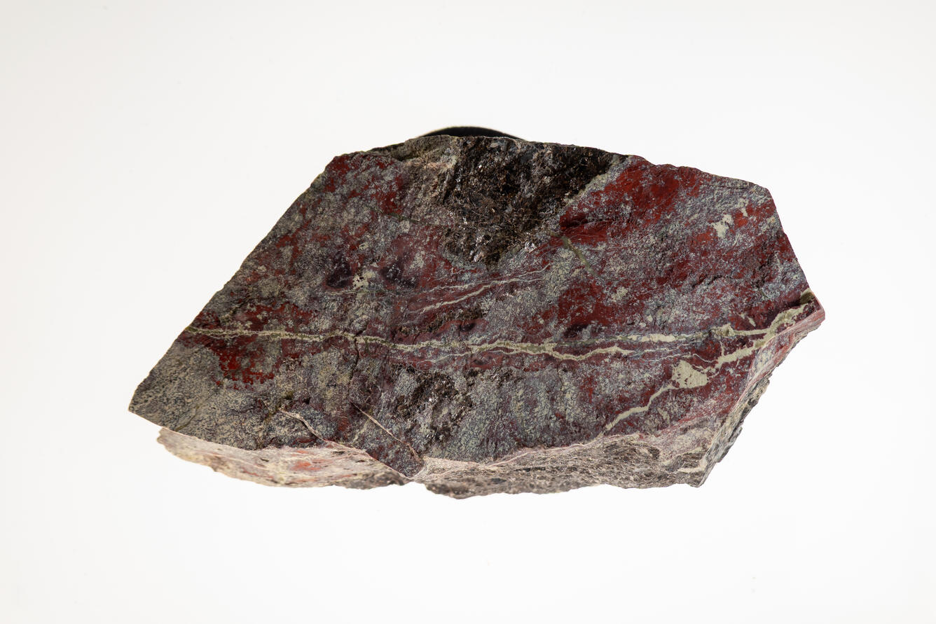 High-definition image of sphalerite and serpentine specimen with layered structure and greenish hue.