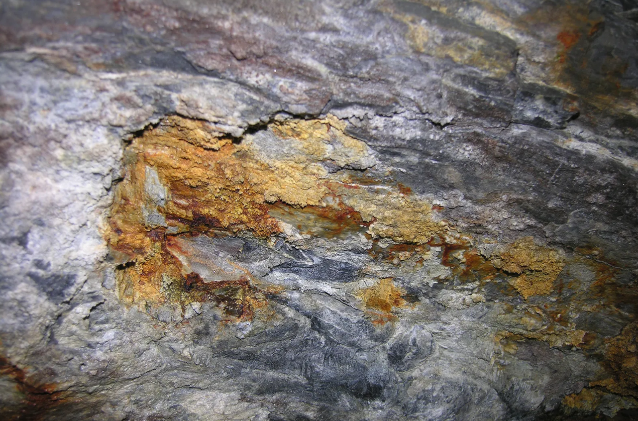 gold rock against a background of grey rock