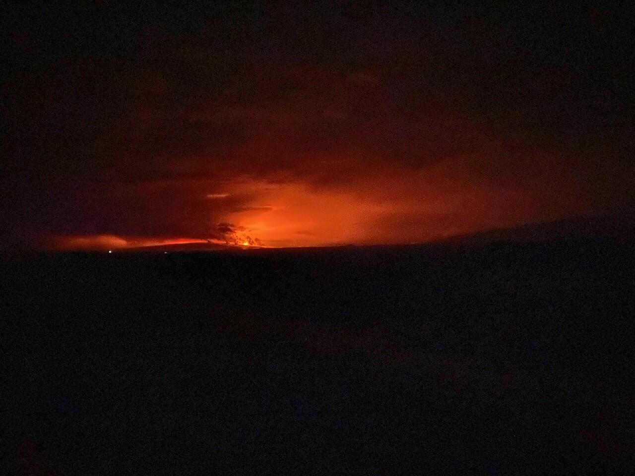 volcanic eruption in the distance