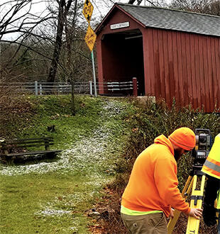 Left side of image: Surveying a bridge in Connecticut