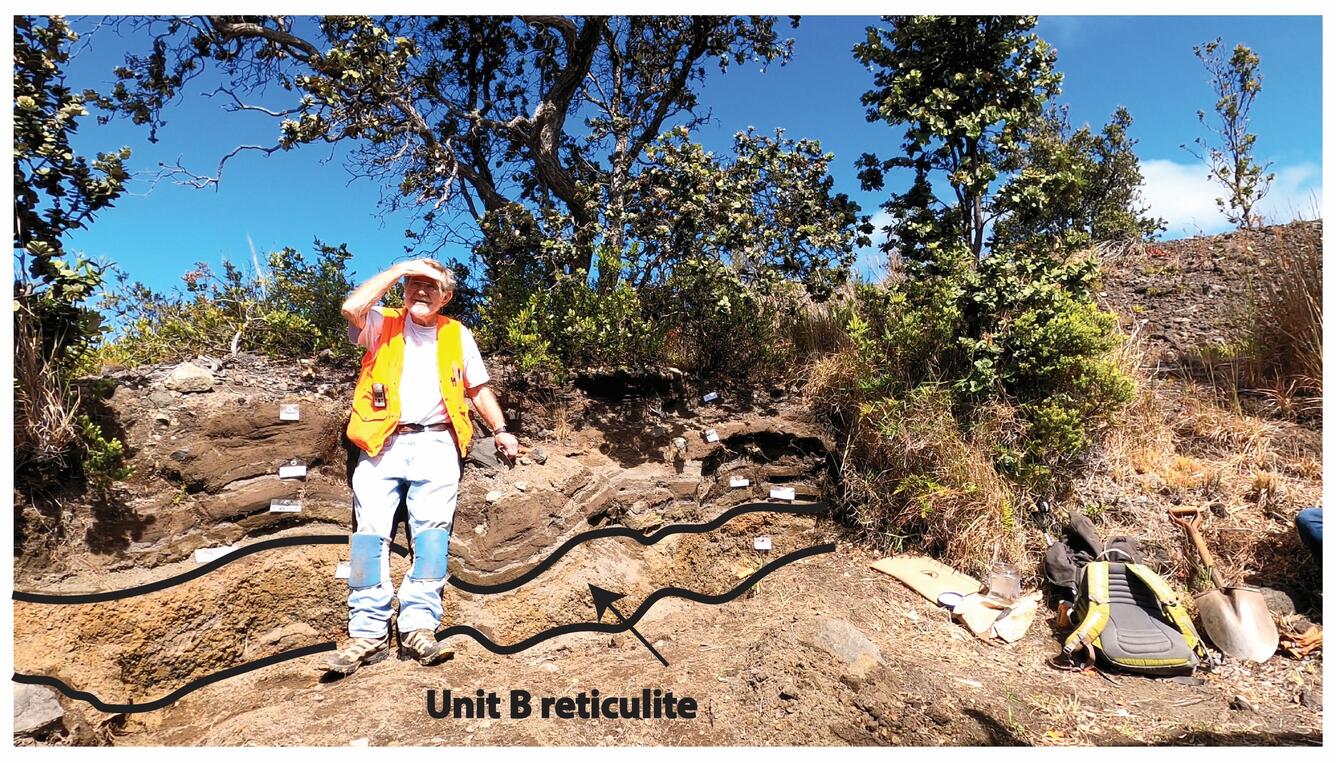 Geologist stands near an outcrop of volcanic fallout with trees growing on it
