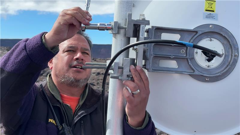 Color image of field engineer installing new antenna