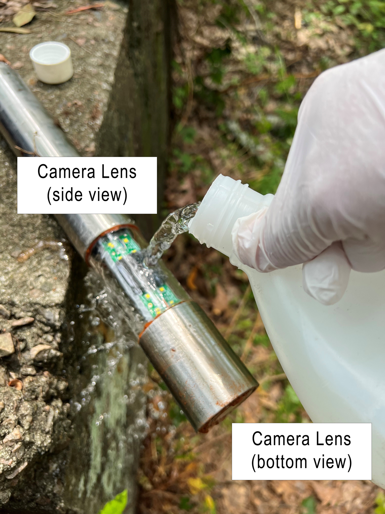 Image of well camera being cleaned with deionized water, before being inserted into a groundwater well.