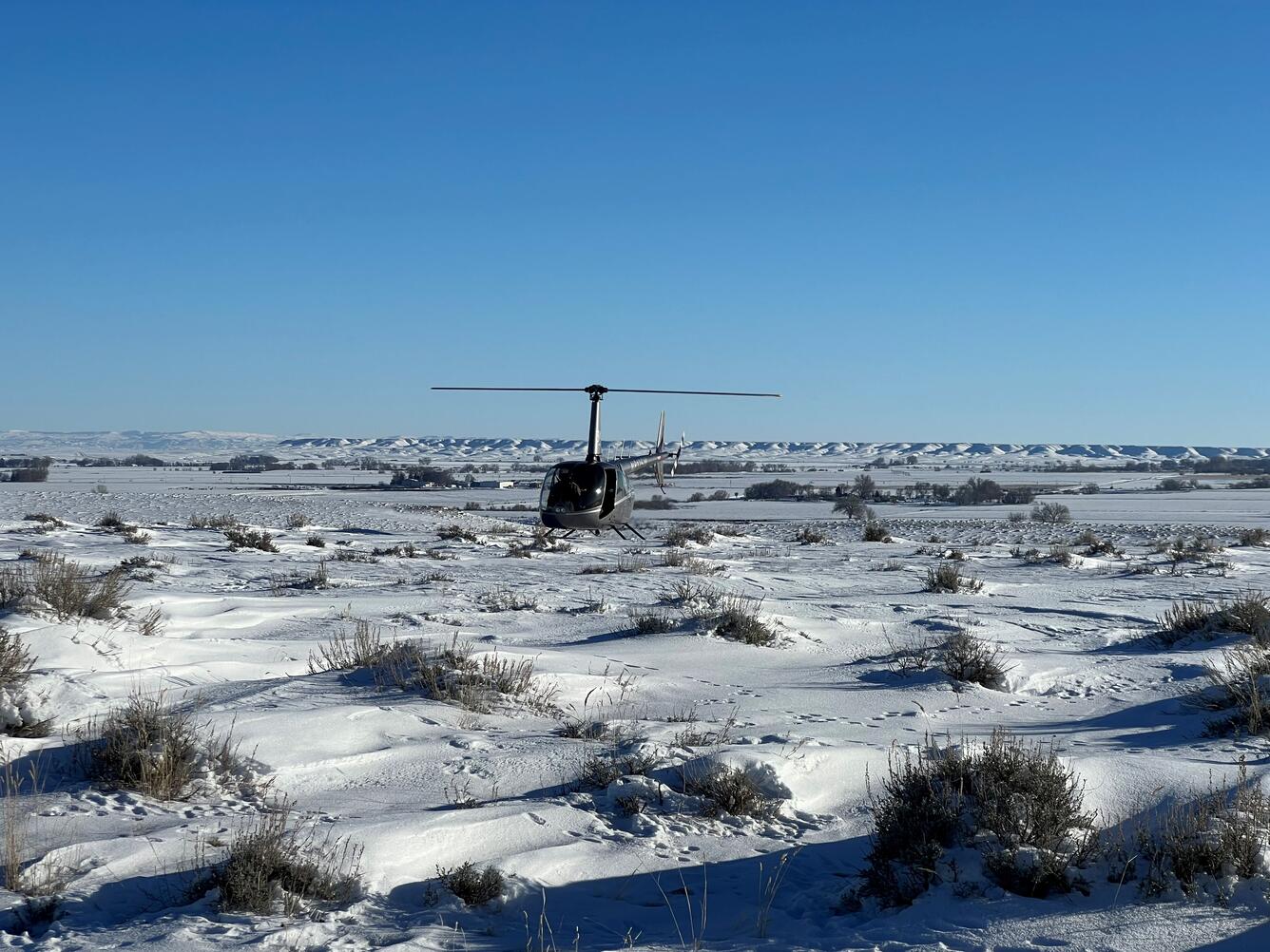 Helicopter landed on the snow in a prairie