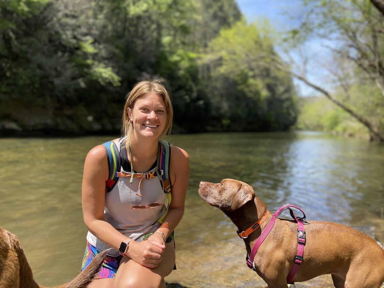 Woman by the water with her dog