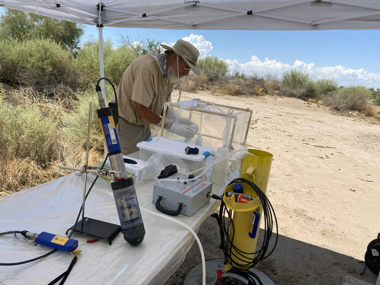 Photograph of USGS scientist collecting a water-quality sample at the Buckfire Restoration Area
