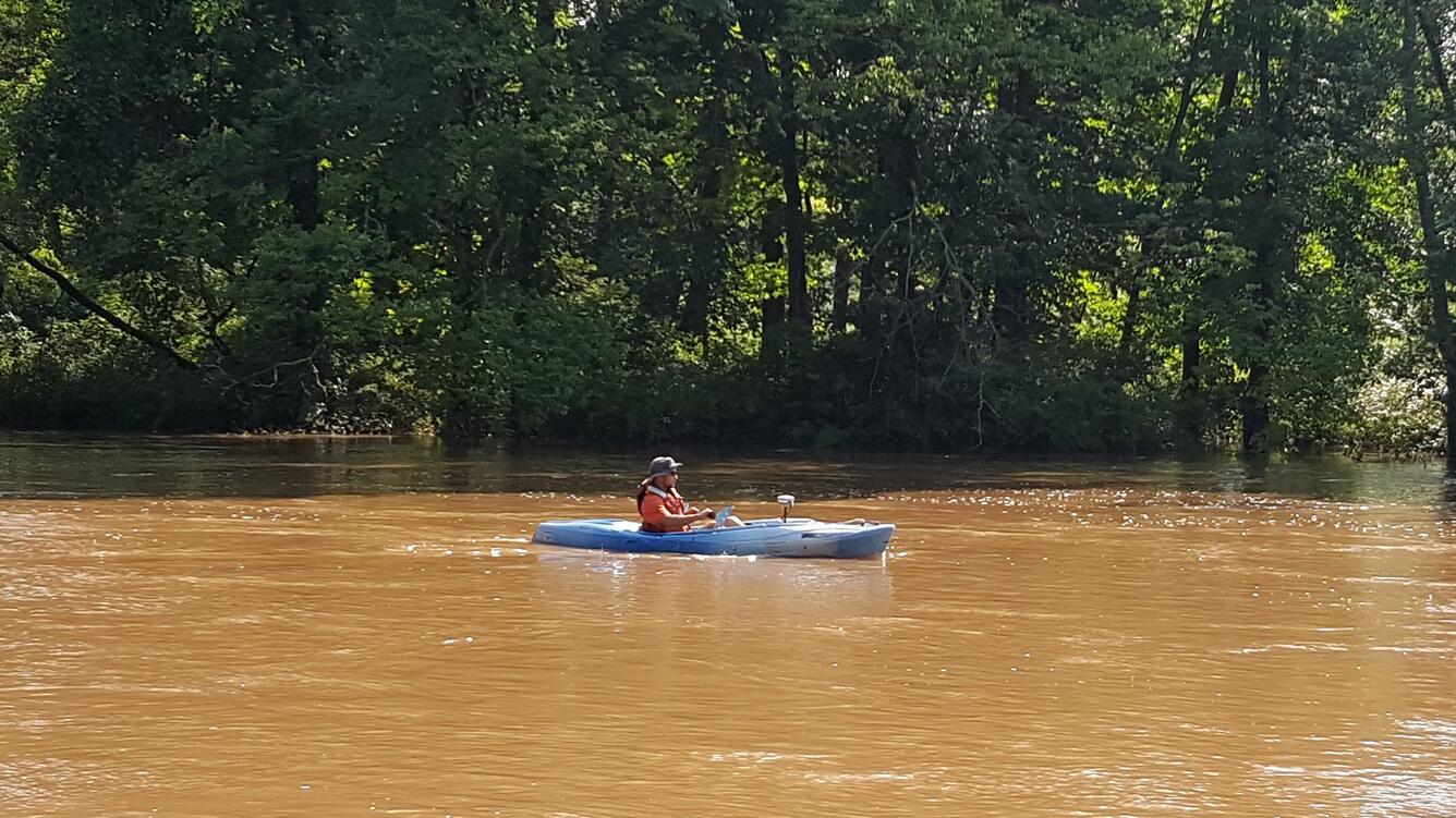 Photo of Hydrologic Technician, Nick Grim taking a surface water discharge measurement.