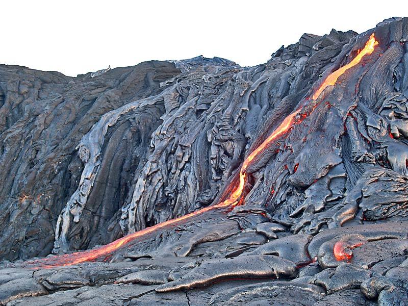 This is a photo of a slender cascade of lava down old sea cliff onto surface of Wilipe`a delta.