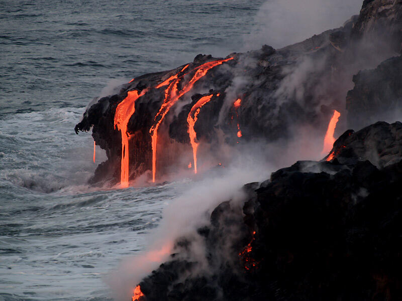 This is a photo of lava pouring into water at and near point on eastern Banana delta.