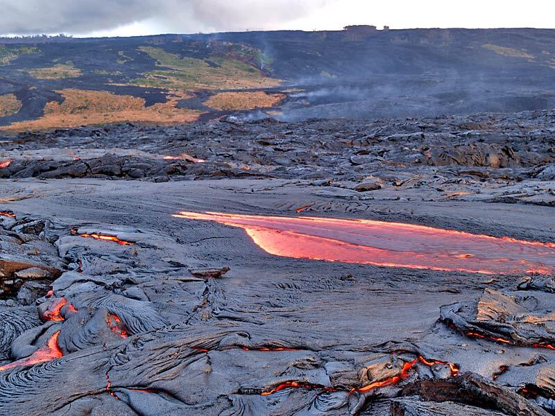 This is a photo of lava wells from under smooth crust of channel in Banana flowing 20 m upstream from front of flow.